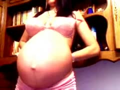On livecam, a gorgeous dark-brown pregnant woman flaunts her enormous belly.